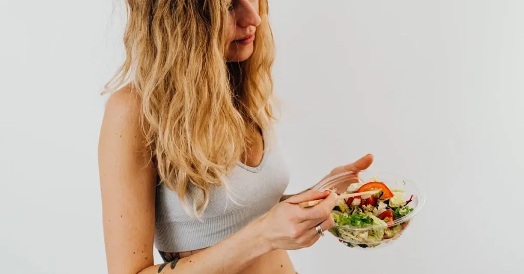 pexels-photo-5714319-5714319 A caucasian woman in a sports bra enjoying a fresh salad, embodying healthy eating and lifestyle.